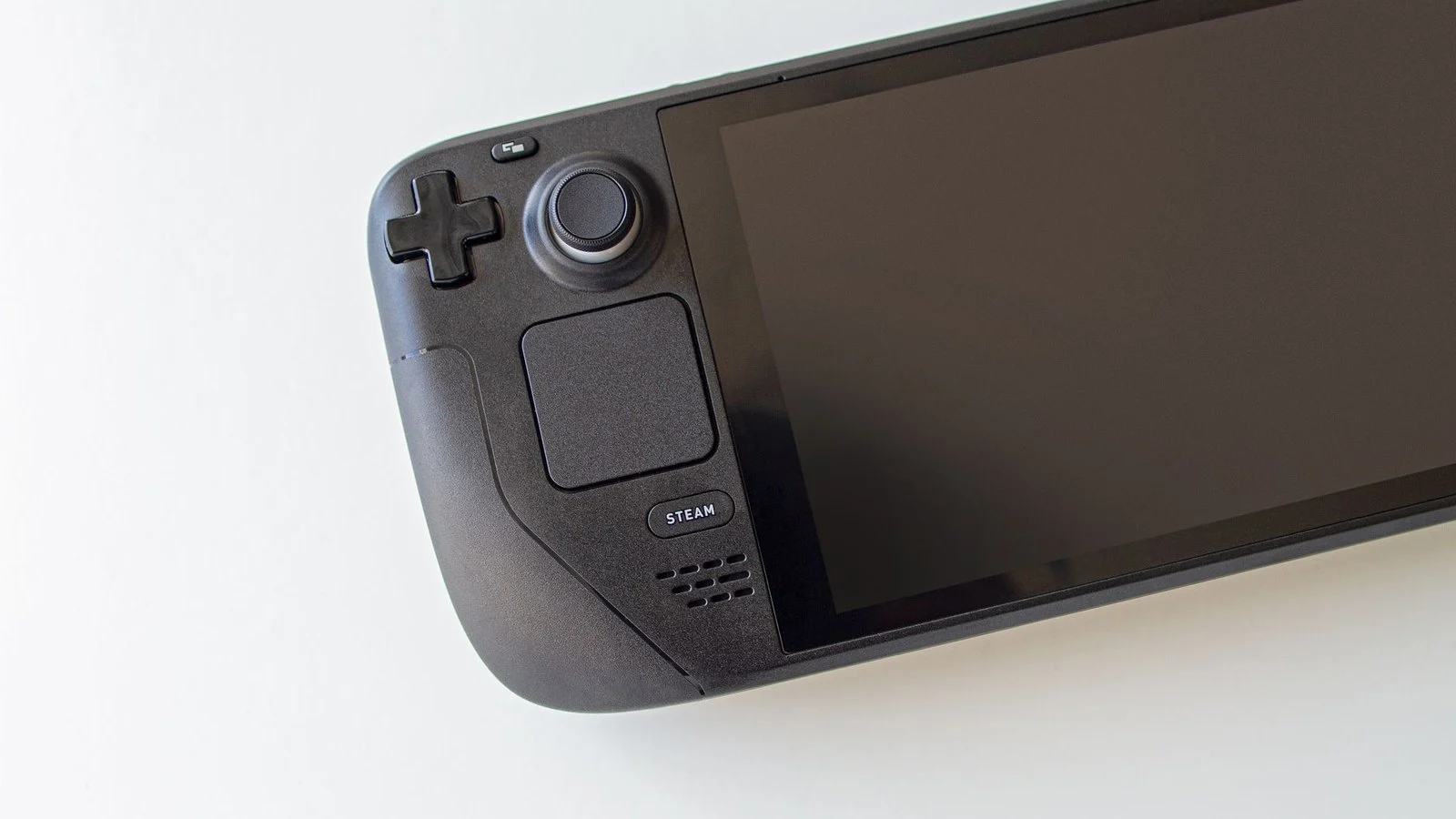 Close-up of a black Steam Deck handheld console's controls and screen, powered off