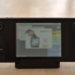 Steam Deck handheld console in its dock with the screen displaying a webpage