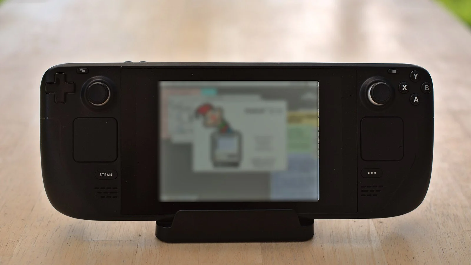 Steam Deck handheld console in its dock with the screen displaying a webpage