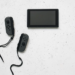 Nintendo Switch console with detached grey Joy-Con controllers on a speckled white surface