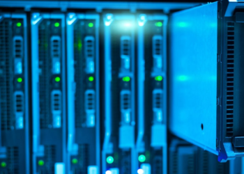 Blue-lit server rack with one blade module partially pulled out, green status LEDs glowing