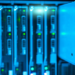 Blue-lit server rack with one blade module partially pulled out, green status LEDs glowing