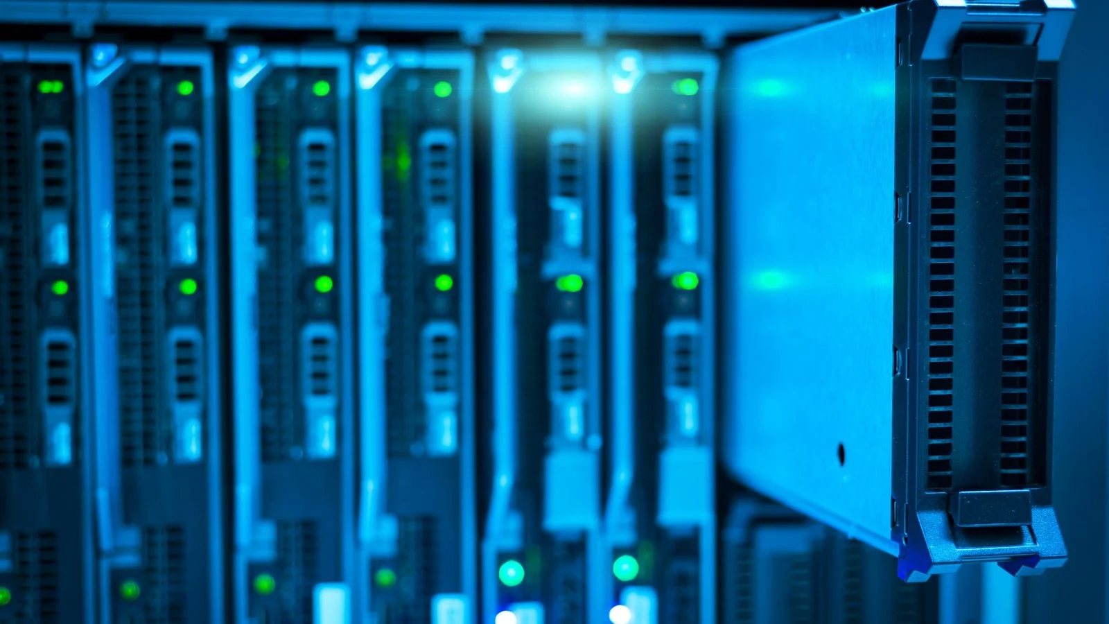 Blue-lit server rack with one blade module partially pulled out, green status LEDs glowing