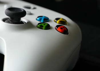 Close-up of a white game controller's thumbstick and colored A, B, X, Y buttons