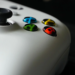 Close-up of a white game controller's thumbstick and colored A, B, X, Y buttons
