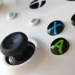 Close-up of a white Xbox controller showing the A, B, X, Y face buttons and joystick