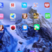 Close-up of a smartphone home screen with Chinese app icons, held in a hand